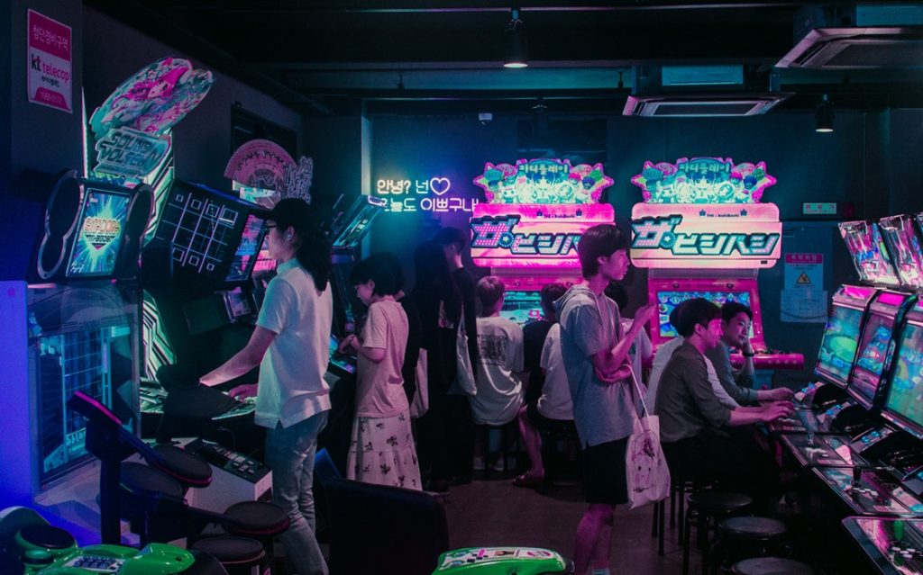 People playing in a korean arcade hall